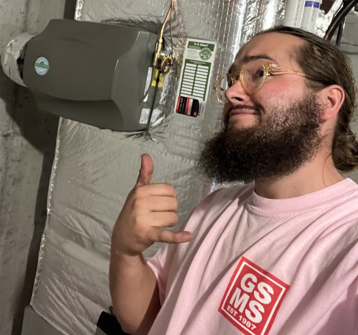 GSMS Technician Wearing Pink Shirt In Front Of HVAC Unit GSMS Technician Wearing Pink Shirt In Front Of Hvac Unit