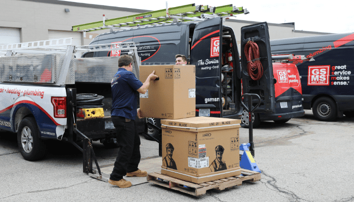 GSMS technicians unloading Lennox HVAC equipment from service vans at their Southern NH location.