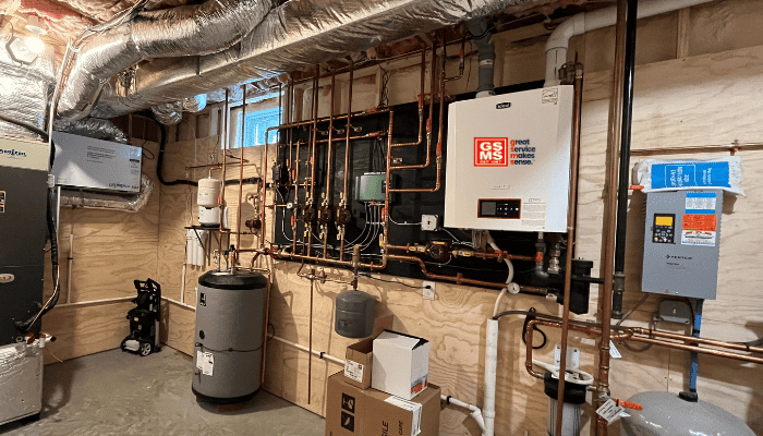 High-efficiency boiler installation by GSMS in New Hampshire, featuring a wall-mounted condensing boiler and advanced hydronic system setup.
