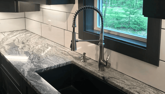 Kitchen sink plumbing with modern faucet installation in a New Hampshire home