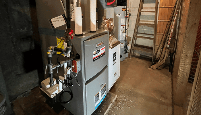High-efficiency Lennox furnace and heating system in a New Hampshire basement, shown as part of fall maintenance and preparation for winter.